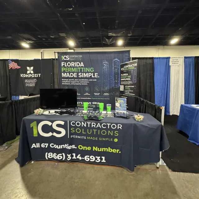 The 1CS booth set up before the show, with the All 67 Counties. One Number. table cover